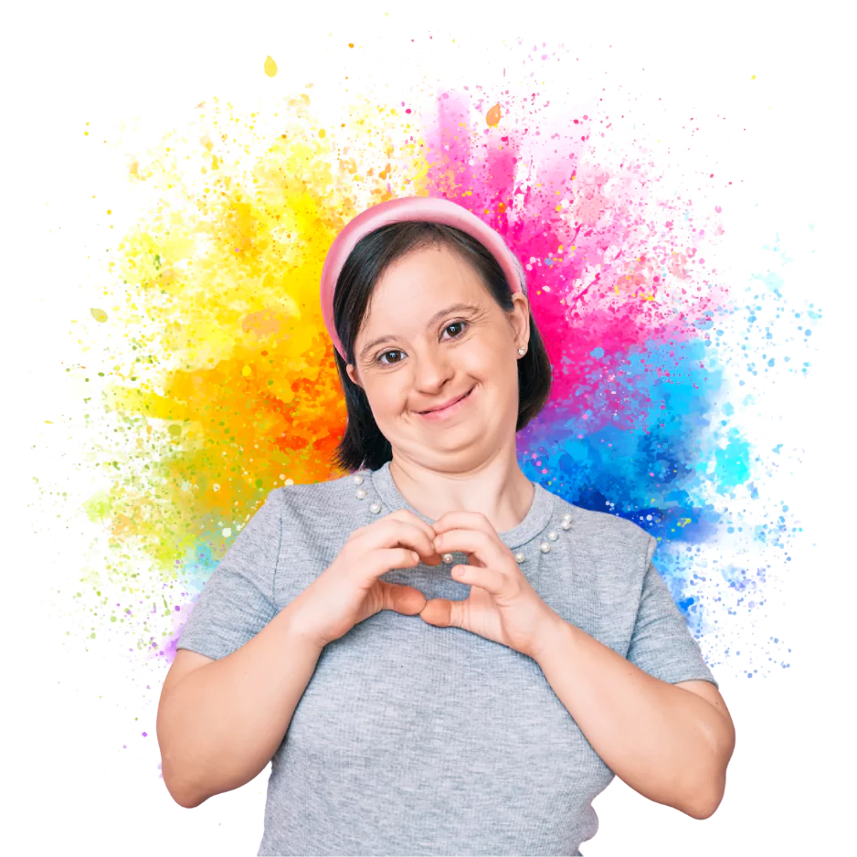 Happy disabled girl with down syndrome making love heart shape with hand and smiling at camera